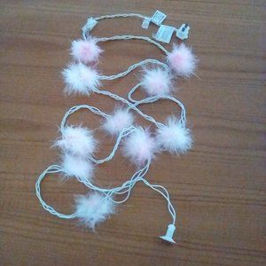 String of lights with pink feathers